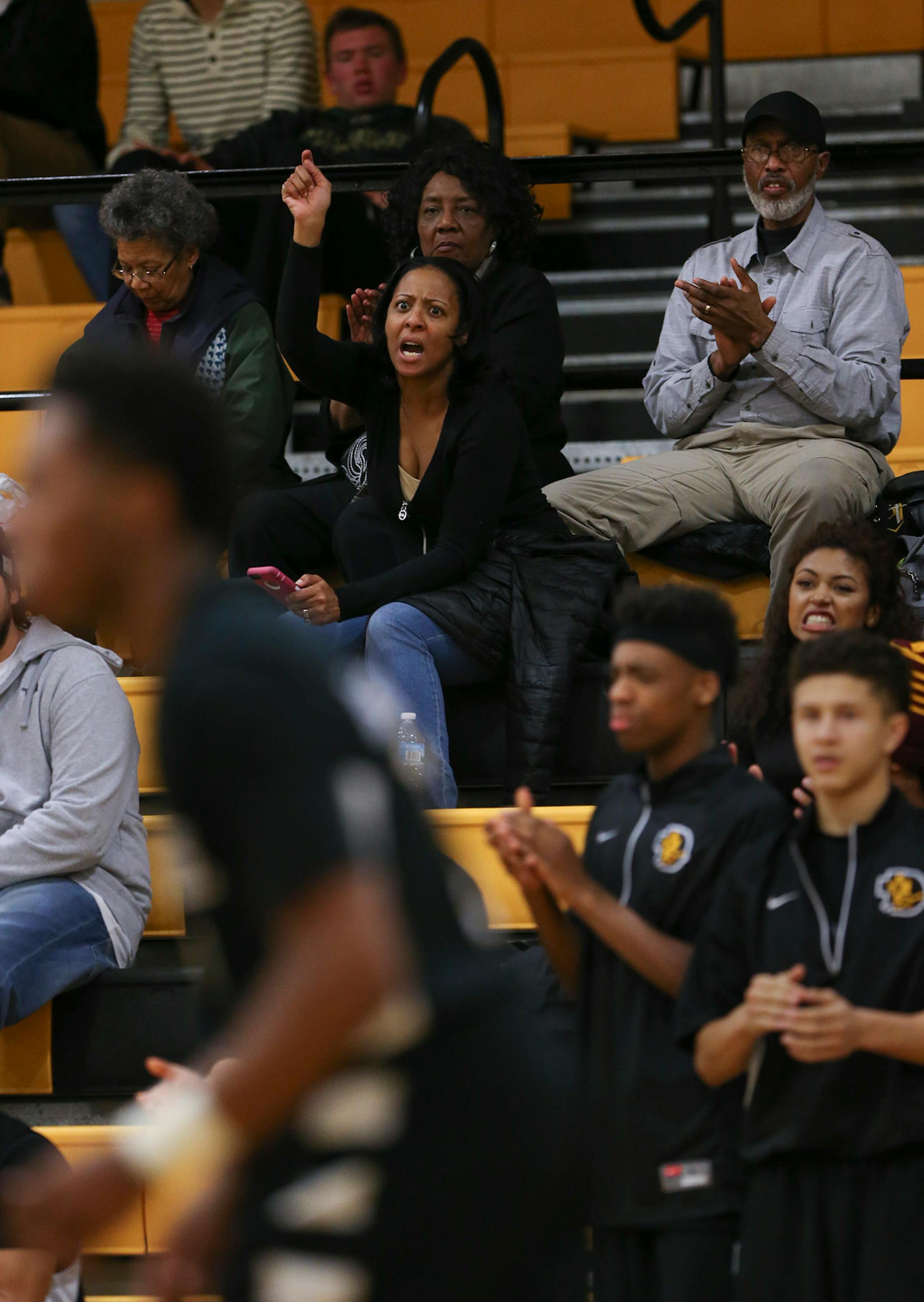 Tanisha Johnson shouted encouragement to her son, Jarvis, foreground, during DeLaSalle's game against Fridley at DeLaSalle. ] JEFF WHEELER ï jeff.wheeler@startribune.com DeLaSalle High School trounced Fridley 69-31 in a boy's basketball game Thursday night, February 12, 2015 at DeLaSalle. The Islanders' Jarvis Johnson is the top preps hoops player in the state and the Gophers' No. 1 recruit for 2015.