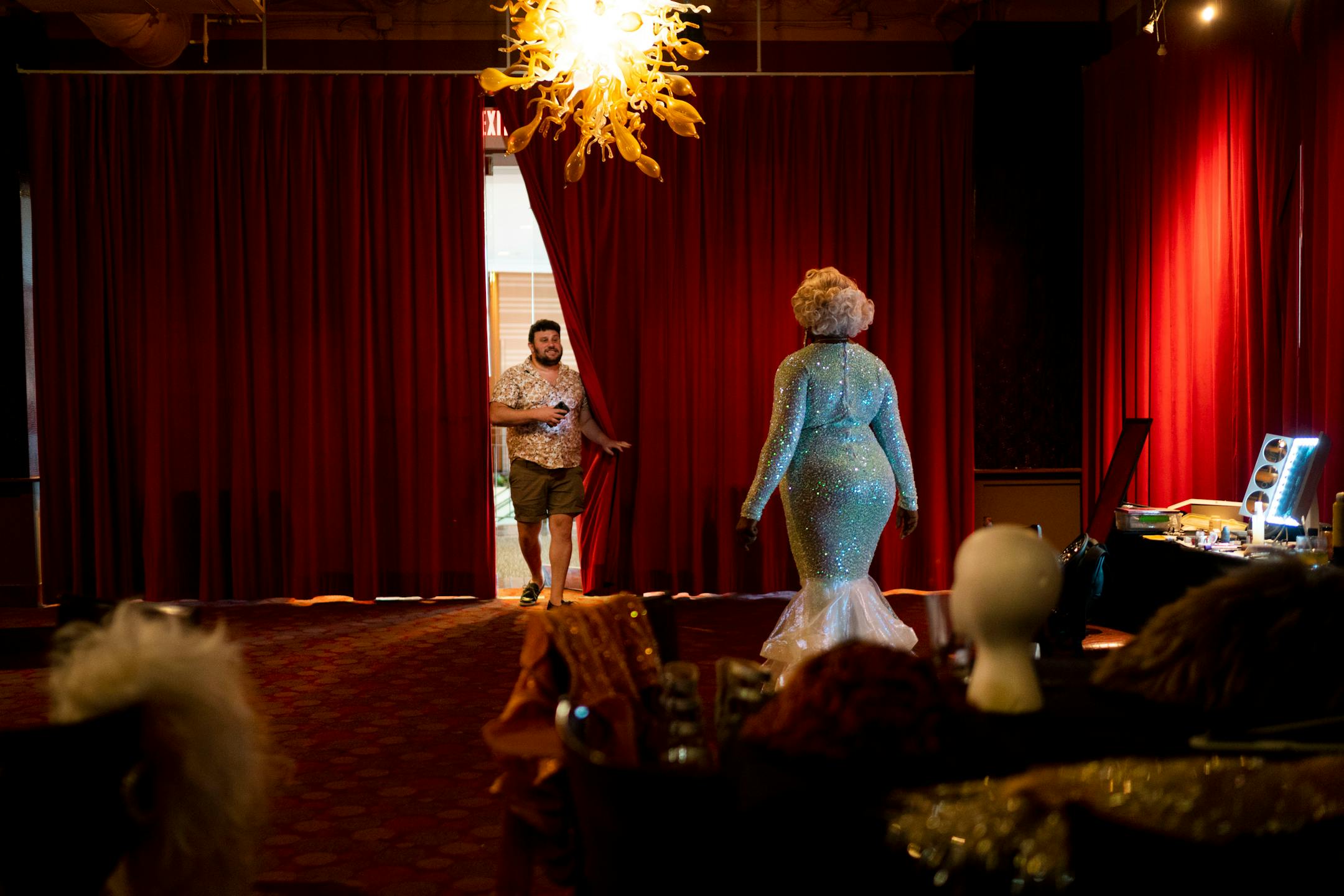 Chad Kampe, center, enters backstage as Sasha Cassadine gets dressed before performing at a weekly drag show hosted by Flip Phone Events At Crave on Sunday, June 20, 2021, in Minneapolis. Kampe is the owner of Flip Phone Events and has become the Twin Cities' leading promoter of drag shows and LGBTQ parties. ] ANTRANIK TAVITIAN • anto.tavitian@startribune.com