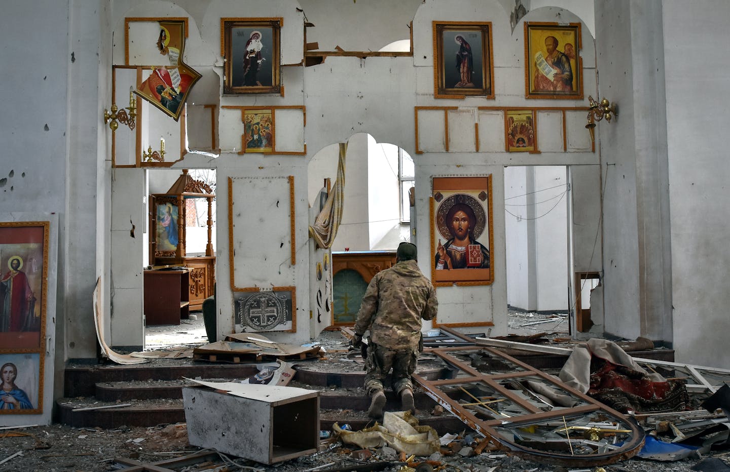 A Ukrainian serviceman kneels and prays in a church damaged in a Russian air raid in the town of Orikhiv, Ukraine, on April 5.