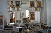 A Ukrainian serviceman kneels and prays in a church damaged in a Russian air raid in the town of Orikhiv, Ukraine, on April 5.