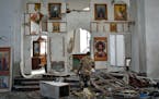 A Ukrainian serviceman kneels and prays in a church damaged in a Russian air raid in the town of Orikhiv, Ukraine, on April 5.