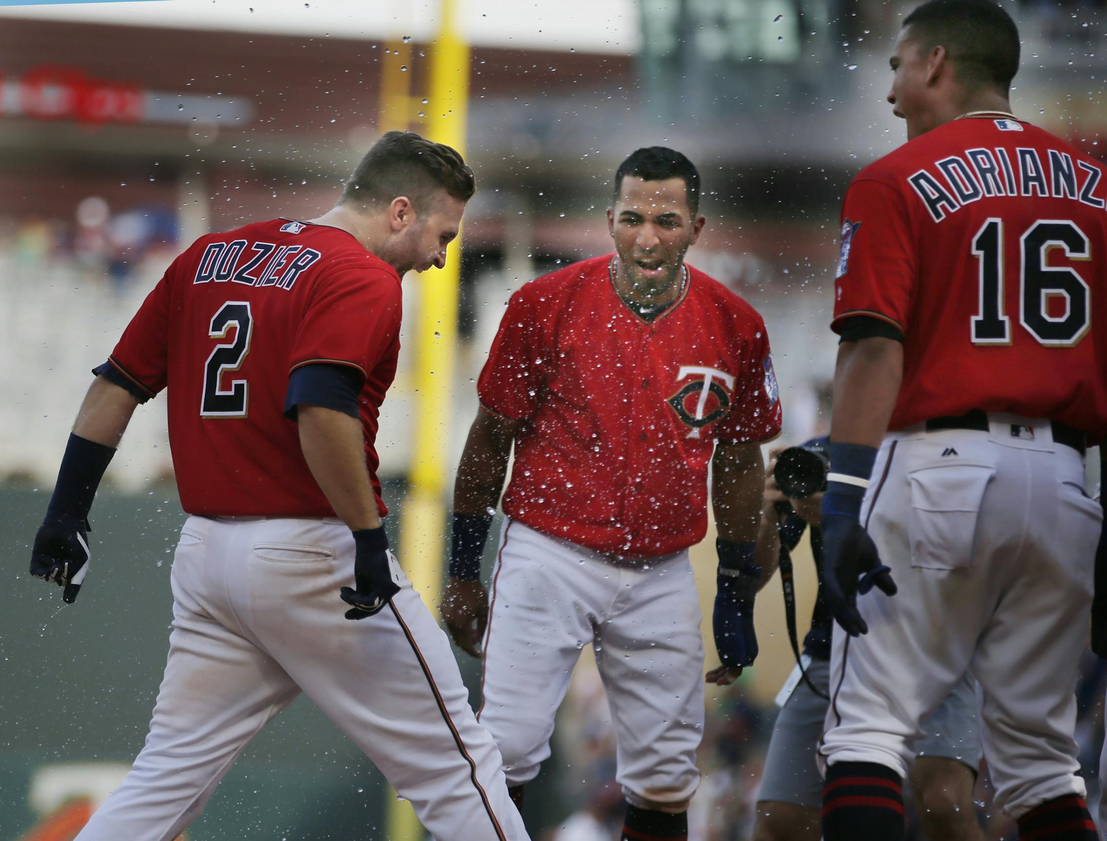 Brian Dozier(2) is greeted by the Twins player for hitting the game winning grand slam to end the game in the 10 innings.] Twins face the Rays on 7/16/18 at Target Field. Richard Tsong-Taatarii&#xef;rtsong-taatarii@startribune.com