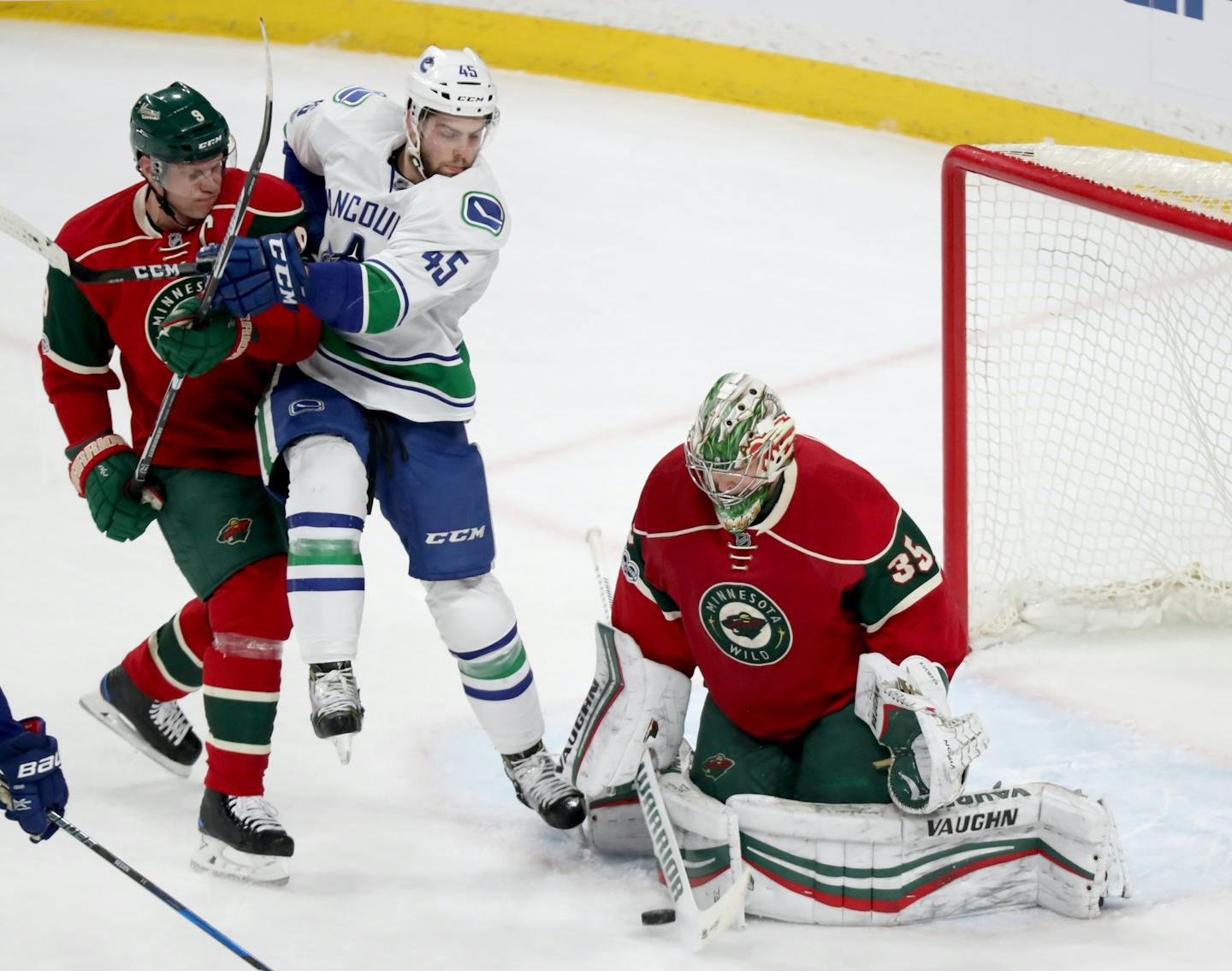 Minnesota Wild goalie Darcy Kuemper makes a save on a shot by Vancouver's Michael Chaput (45) as the Wild's Mikko Koivu (9) plays defense during the 1st period Saturday, March 25, 2017, at the Xcel Energy Center in St. Paul, MN.