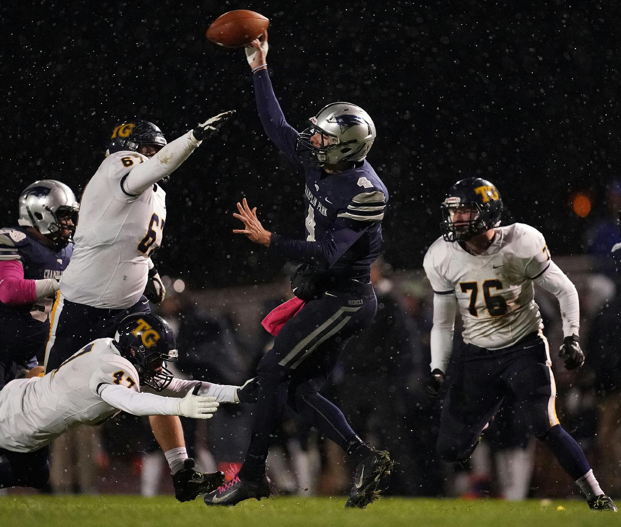 Champlin Park quarterback Jaice Miller (4) made a pass under pressure from Totino-Grace defensive end Mason Miller (47) and defensive end Austin Hall (67) in the second half. ] ANTHONY SOUFFLE • anthony.souffle@startribune.com Champlin Park played Totino-Grace in an MSHSL football game Friday, Oct. 11, 2019 at Champlin Park High School in Champlin, Minn.
