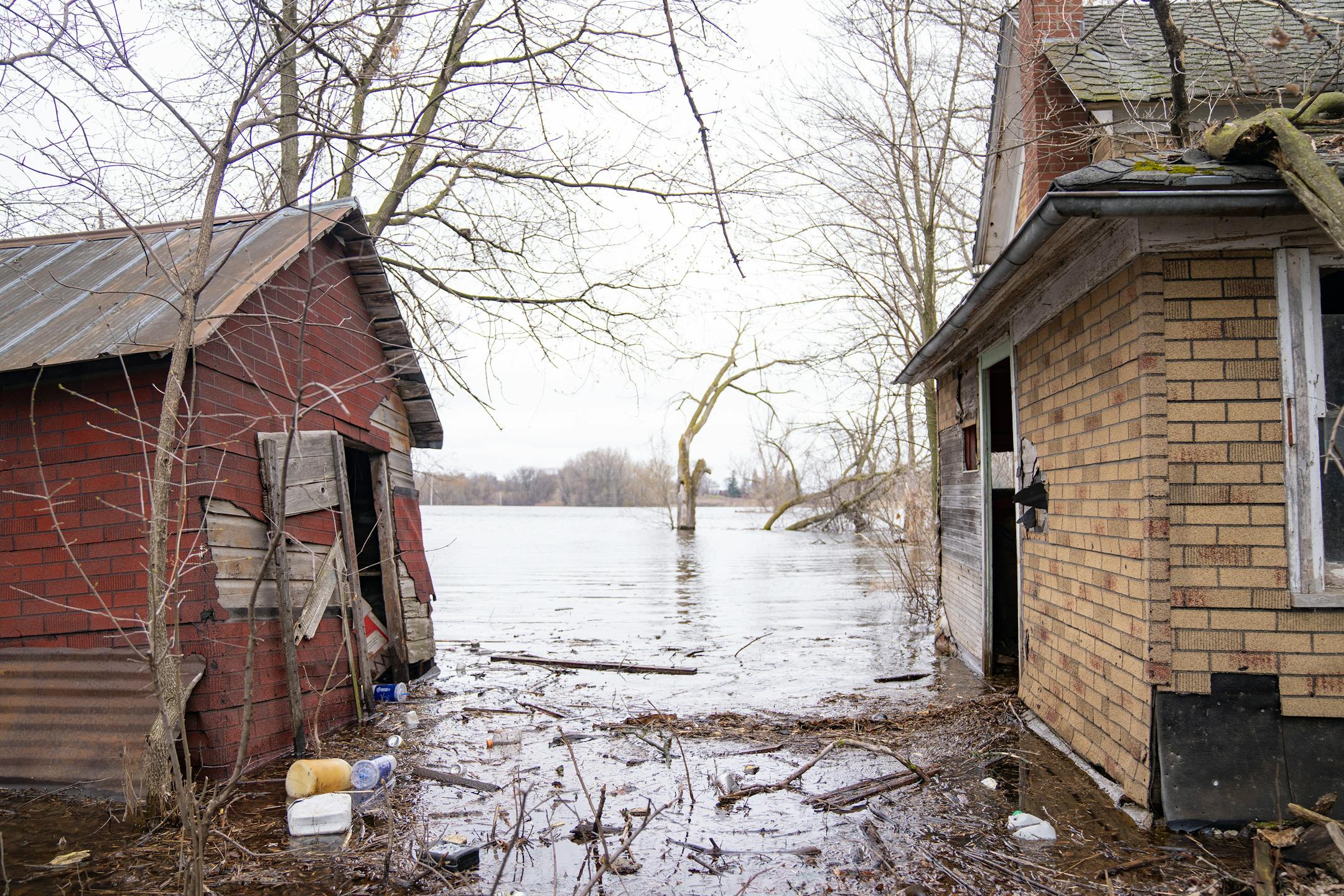 Floodwaters surround and enter an abandoned house just off County Road 17 on Wednesday, April 19, 2023, in Delano, Minn.