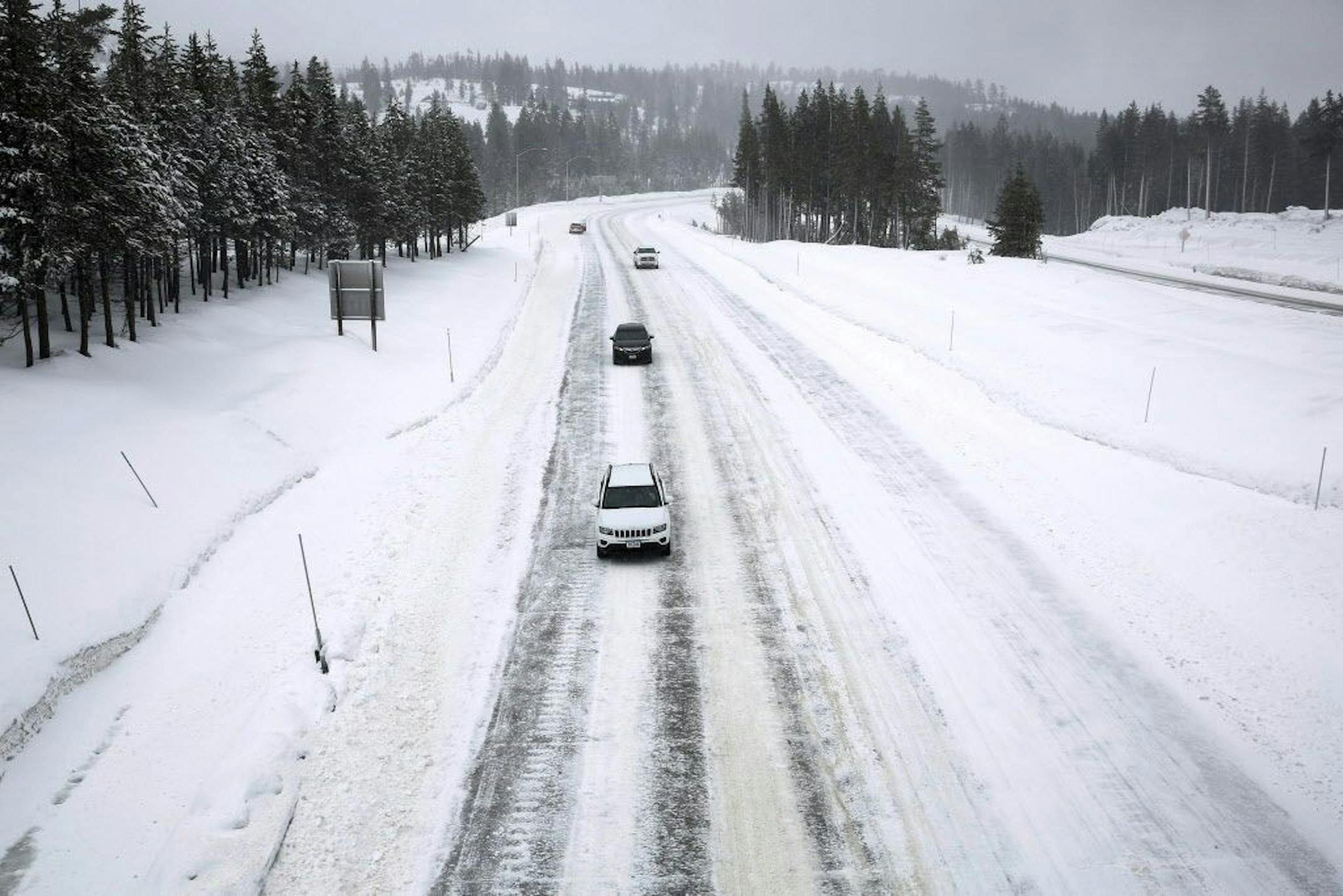 Traffic along I80 while snowfalls at the Donner Pass Road exit Monday, Jan. 9, 2017 in Soda Springs, Calif. A roaring "Pineapple Express" weather system that drenched the northern Sierra Nevada over the weekend has begun to ease, but forecasters warned Monday that it would soon be replaced by yet another storm and plummeting temperatures.