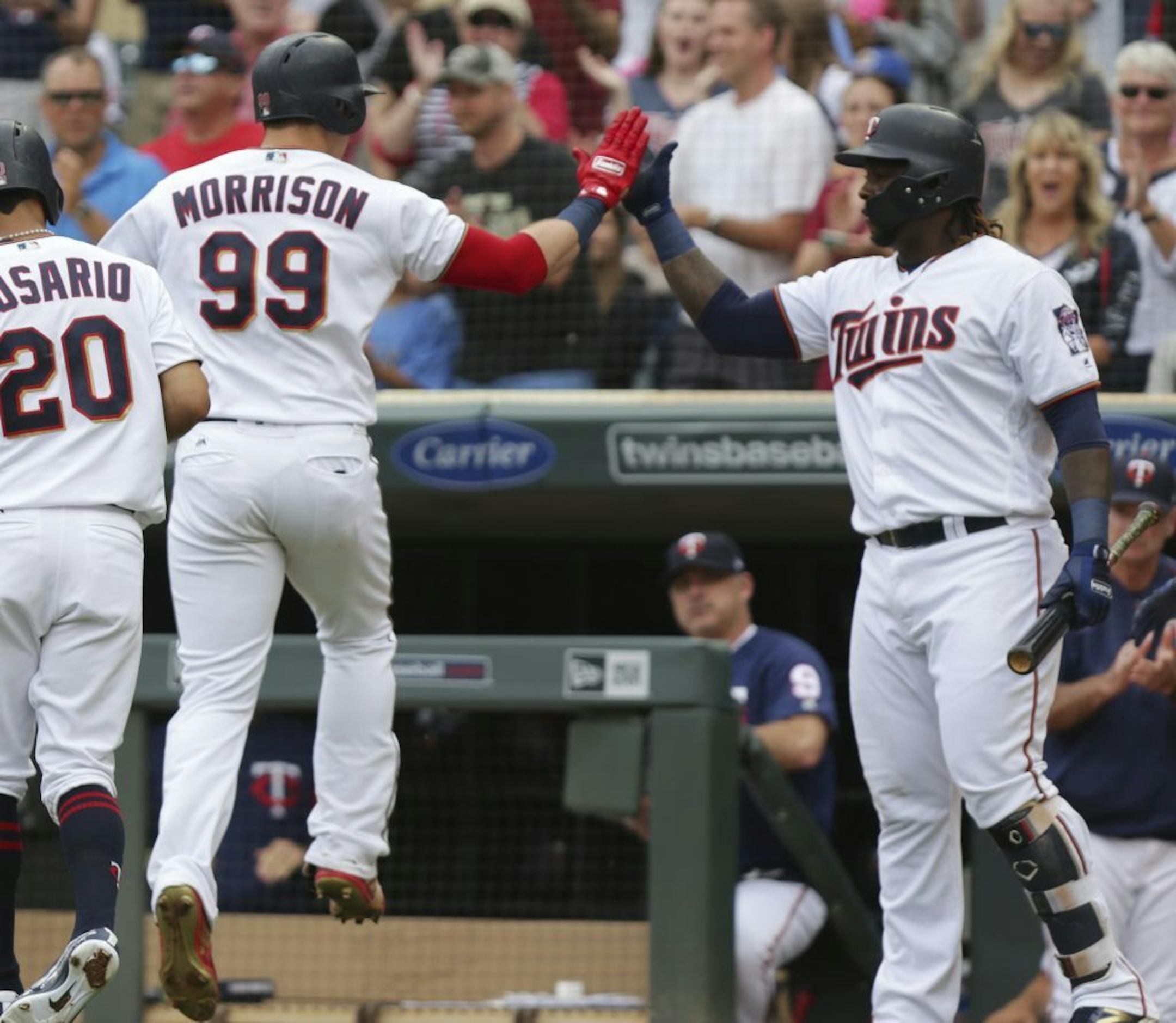 Minnesota Twins Logan Morrison (99) celebrates with teammate Miguel Sano after hitting a two-run home run against the Los Angeles Angels in the first inning of a baseball game Sunday, June 10, 2018, in Minneapolis.