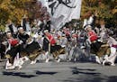 Participants jump as they dance through a street during the annual "Yosakoi" festival in Tokyo Sunday, Nov. 1, 2015. Yosakoi is a unique and modern re