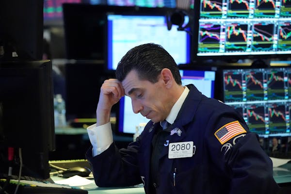 A trader while working the floor of the New York Stock Exchange, Friday, March 20, 2020, in New York.