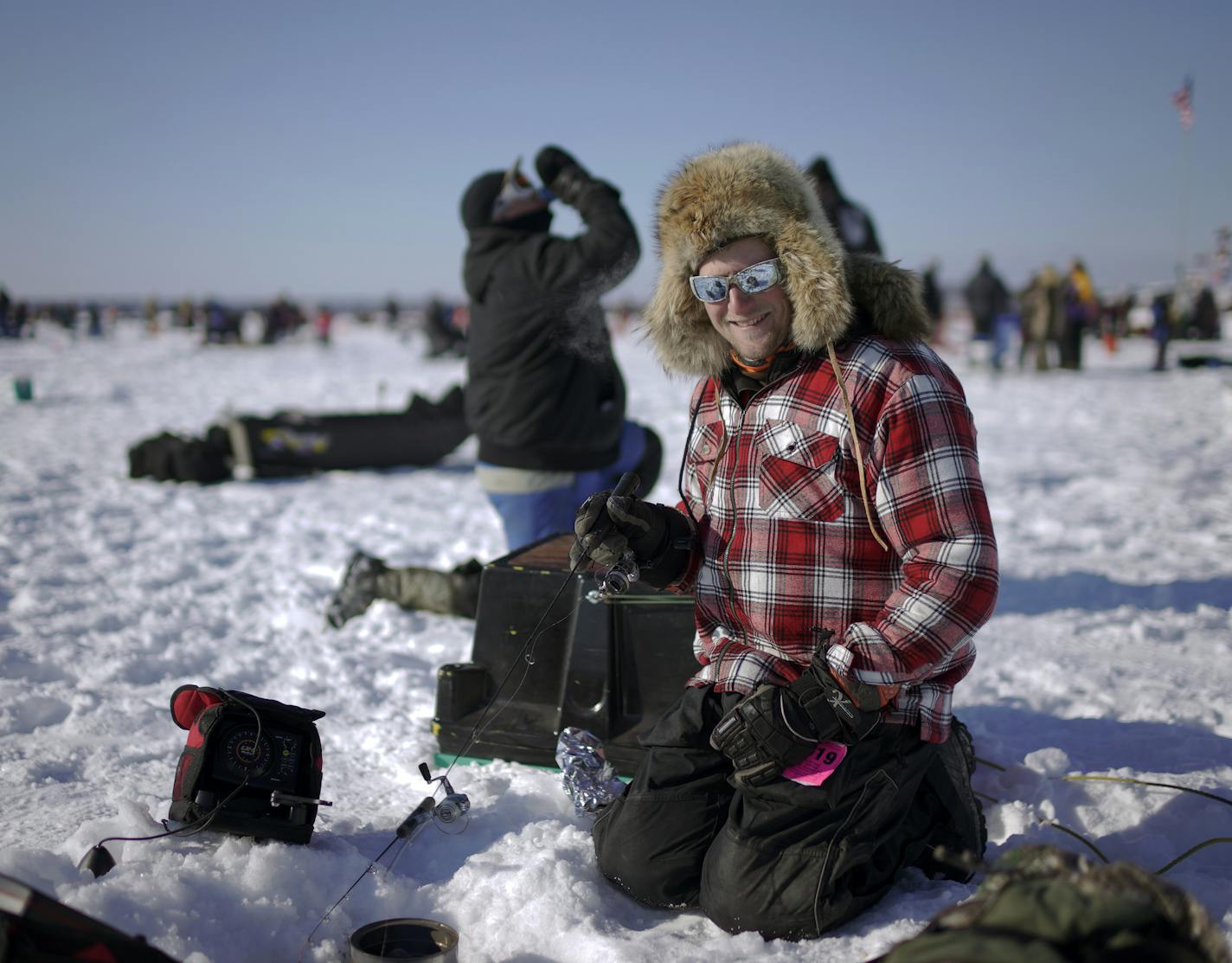 Decked out in his best winter fur, Dustin Erickson of Brainerd was trying to jig his way to a big prize Saturday on Gull Lake for the Brainerd JC's Ice Fishing Extravaganza 2019 - The extravaganza is the largest charitable ice fishing event in the world&#xd1;typically hosting about 10,000 anglers every January, and doling out $200,000 in cash and prizes annually. ]
BRIAN PETERSON &#xa5; brian.peterson@startribune.com
Brainerd, MN Saturday, January 26, 2019