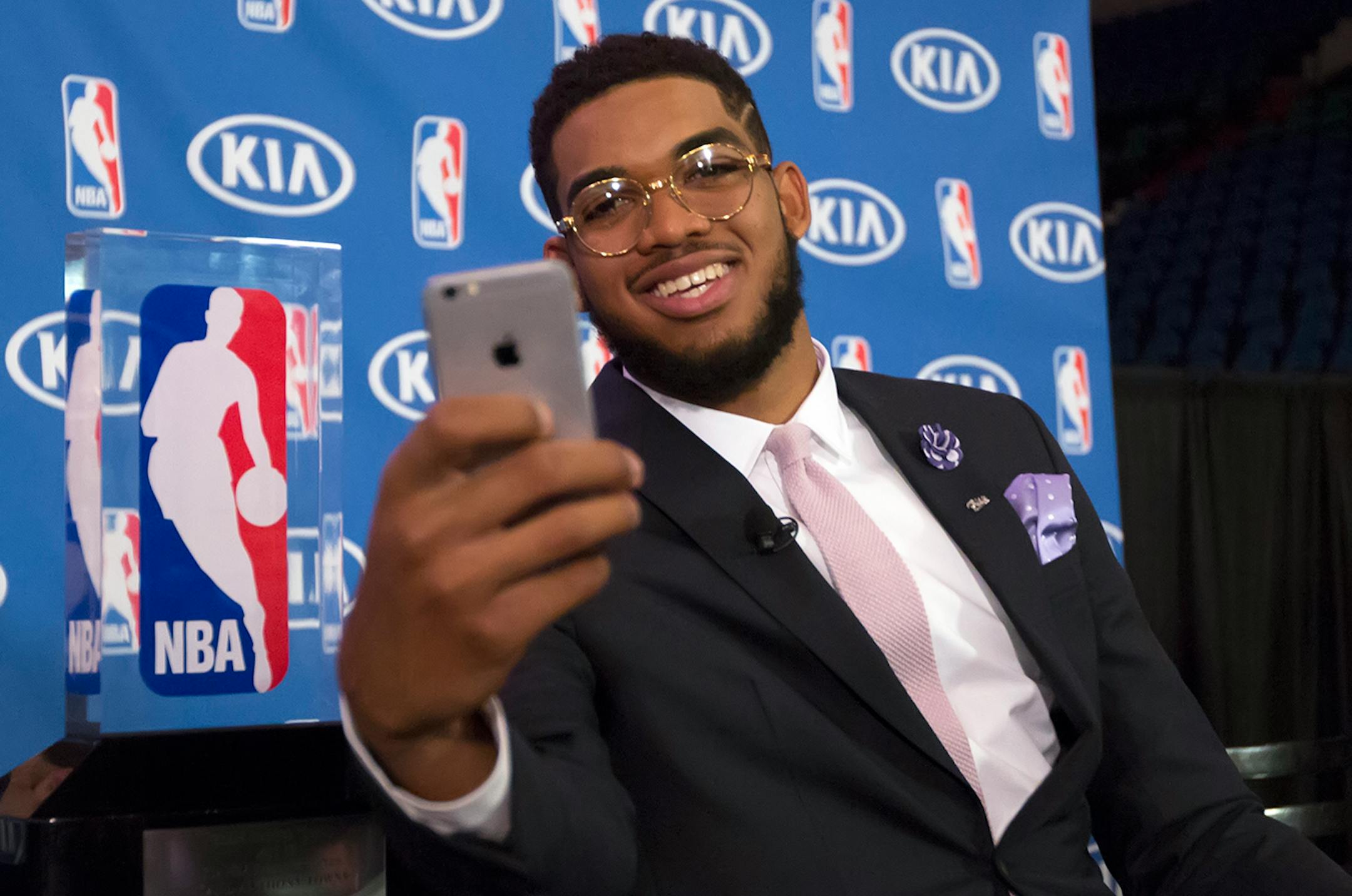 Timberwolve's Karl-Anthony Towns takes a selfie with the NBA Rookie of the Year trophy after a press conference announcing the award Monday morning at Target Center.