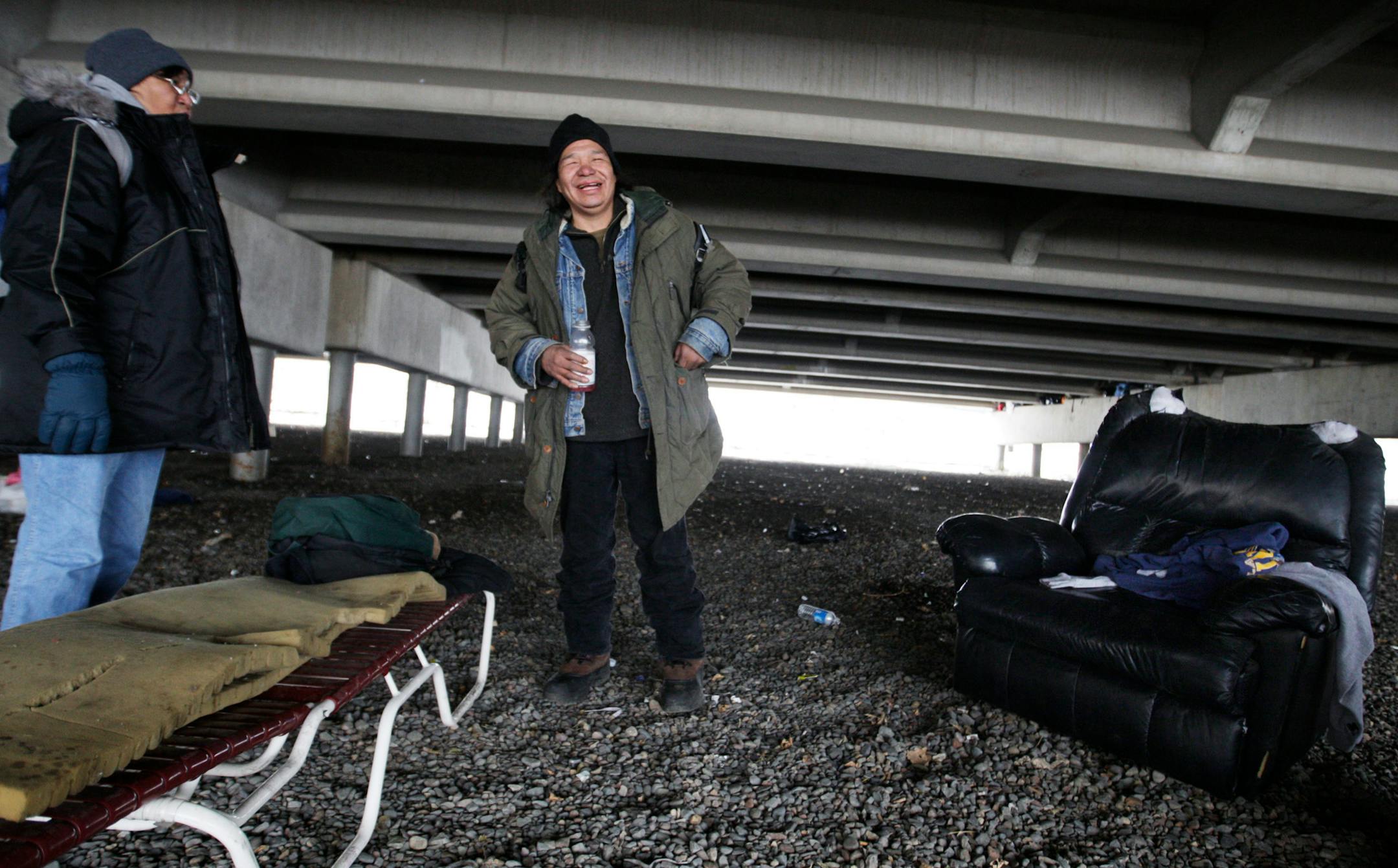 Under the I-394 overpass, Charlene Goggleeye and her partne, Dennis Wounded Shield, relaxed in their "living room." Their addiction to alcohol keeps them moving in and out of a permanent living situation.