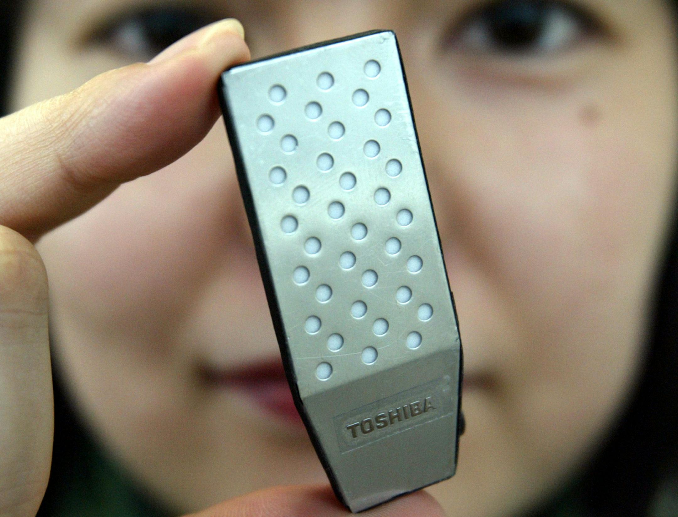 Yumiko Kajino, who works for Toshiba Corp., displayed a prototype of what the electronics company says is the world's smallest direct methanol fuel cell in Tokyo four years ago. Toshiba says that it plans to begin production of such fuel cells within a year for use in mobile phones and laptop computers.