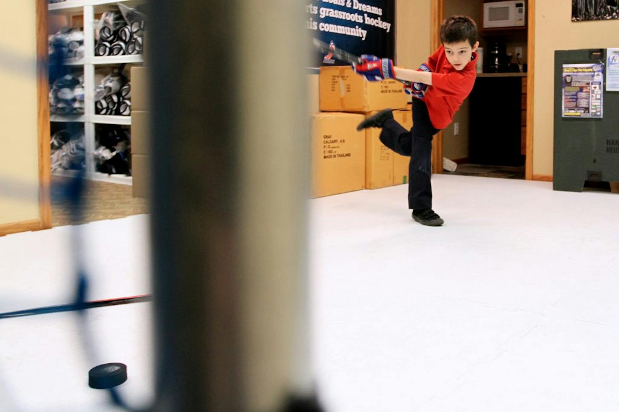 Milan Tomaska practiced his shot at Defending the Blue Line. Milan got a new set of hockey equipment at no cost to his family thanks to Shane Hudella's organization. It was co-founded by Hudella, who grew up in Hastings playing goalie in boots in pickup hockey games because he had no skates until he was 17.