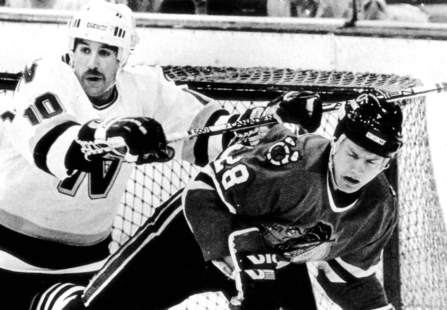 April 2, 1986 Minnesota North Star Gordie Roberts (10) clears Steve Larmer (28) out of the goal area during the first period of game played 4/1. Mark Peterson, UPI