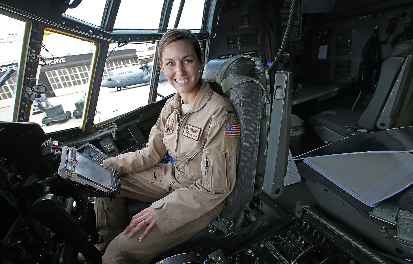 Lt. Alicia Makoutz sat in the cockpit of one of the C-130 cargo planes she will fly. Makoutz said she has never felt targeted as one of the few female pilots of military cargo planes.