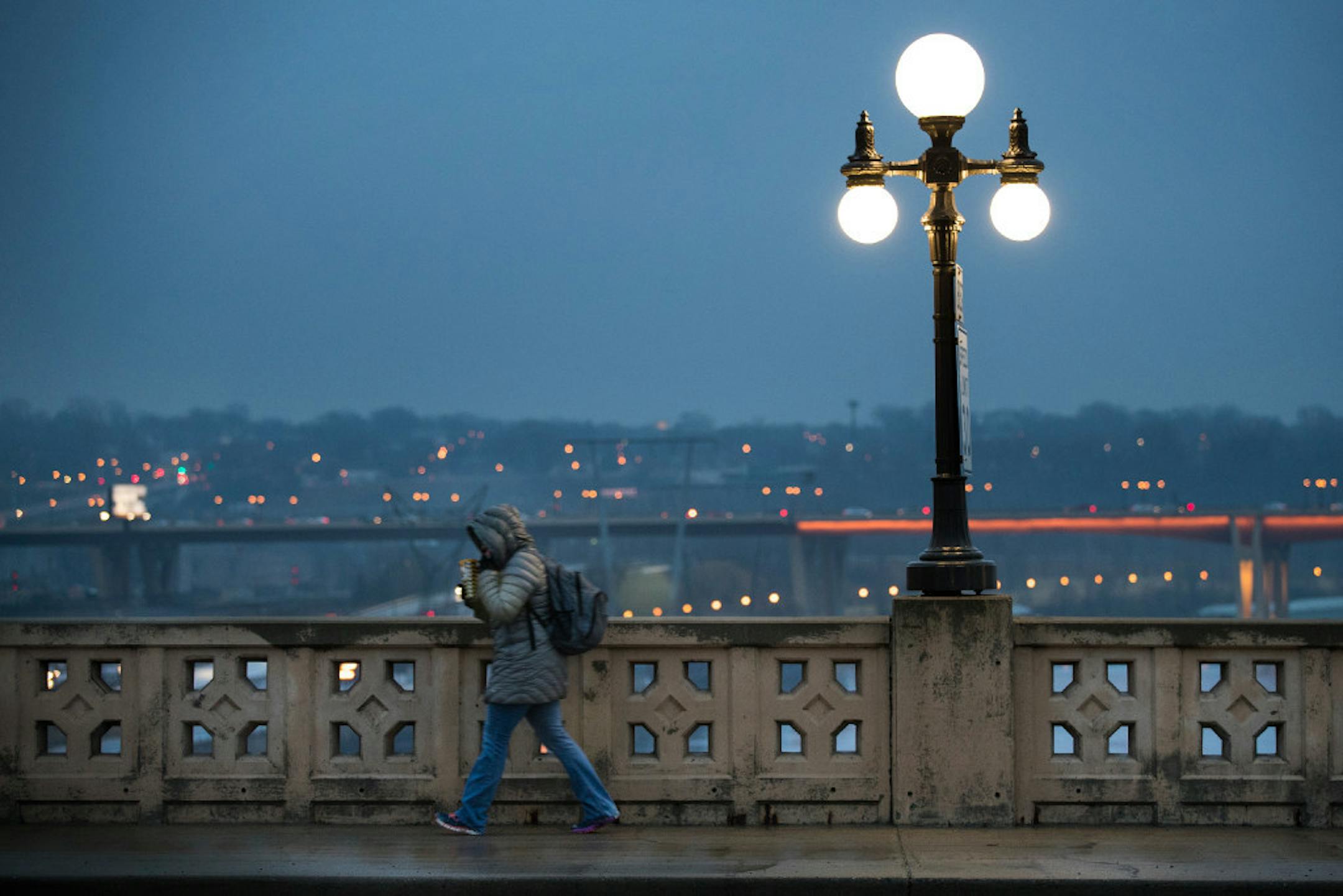 A commuter walks across the Robert Street bridge into downtown St. Paul last week.