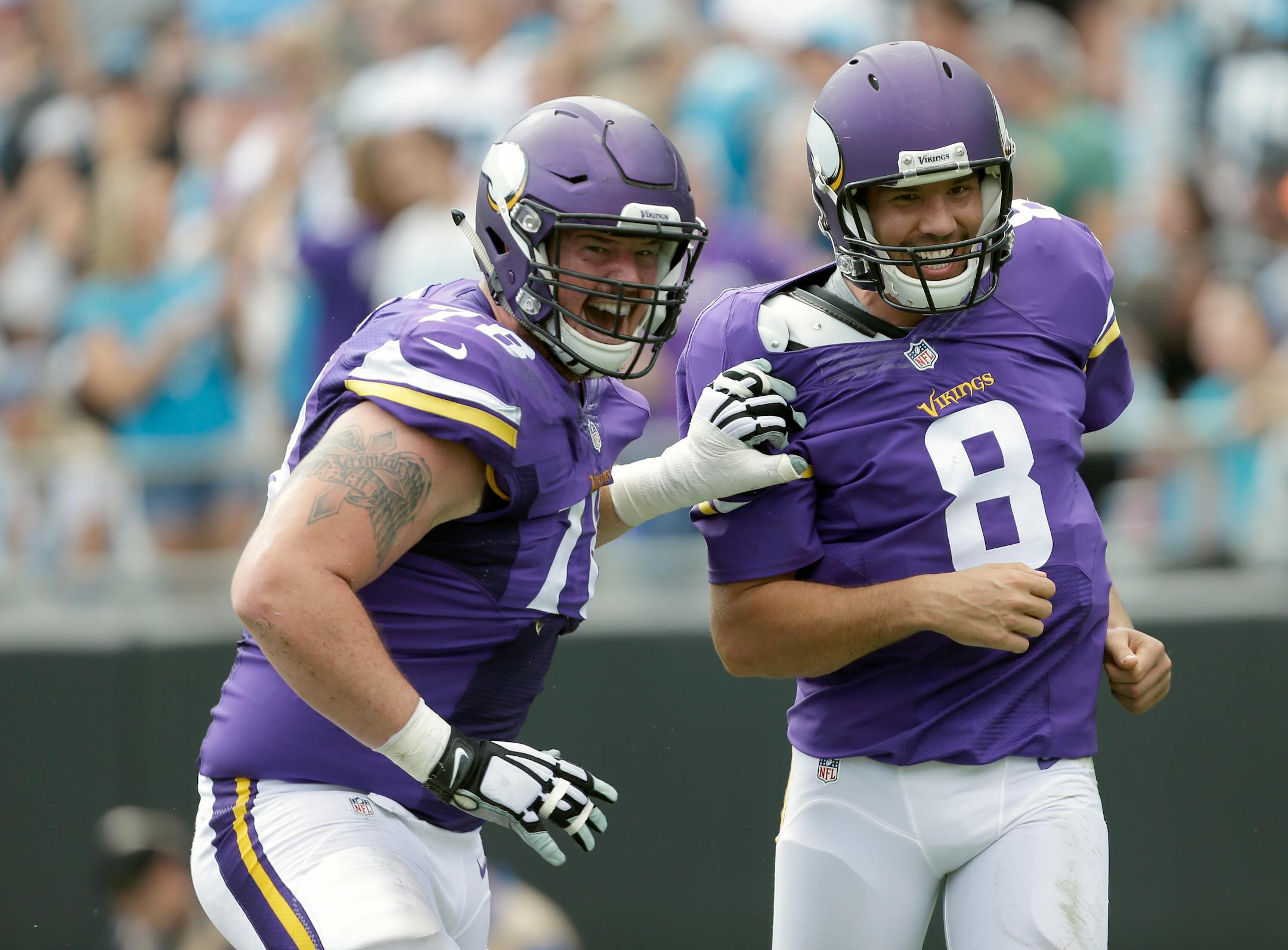 Minnesota Vikings' Jeremiah Sirles (78) celebrates a touchdown with teammate Sam Bradford (8) during the second half against Carolina in September.