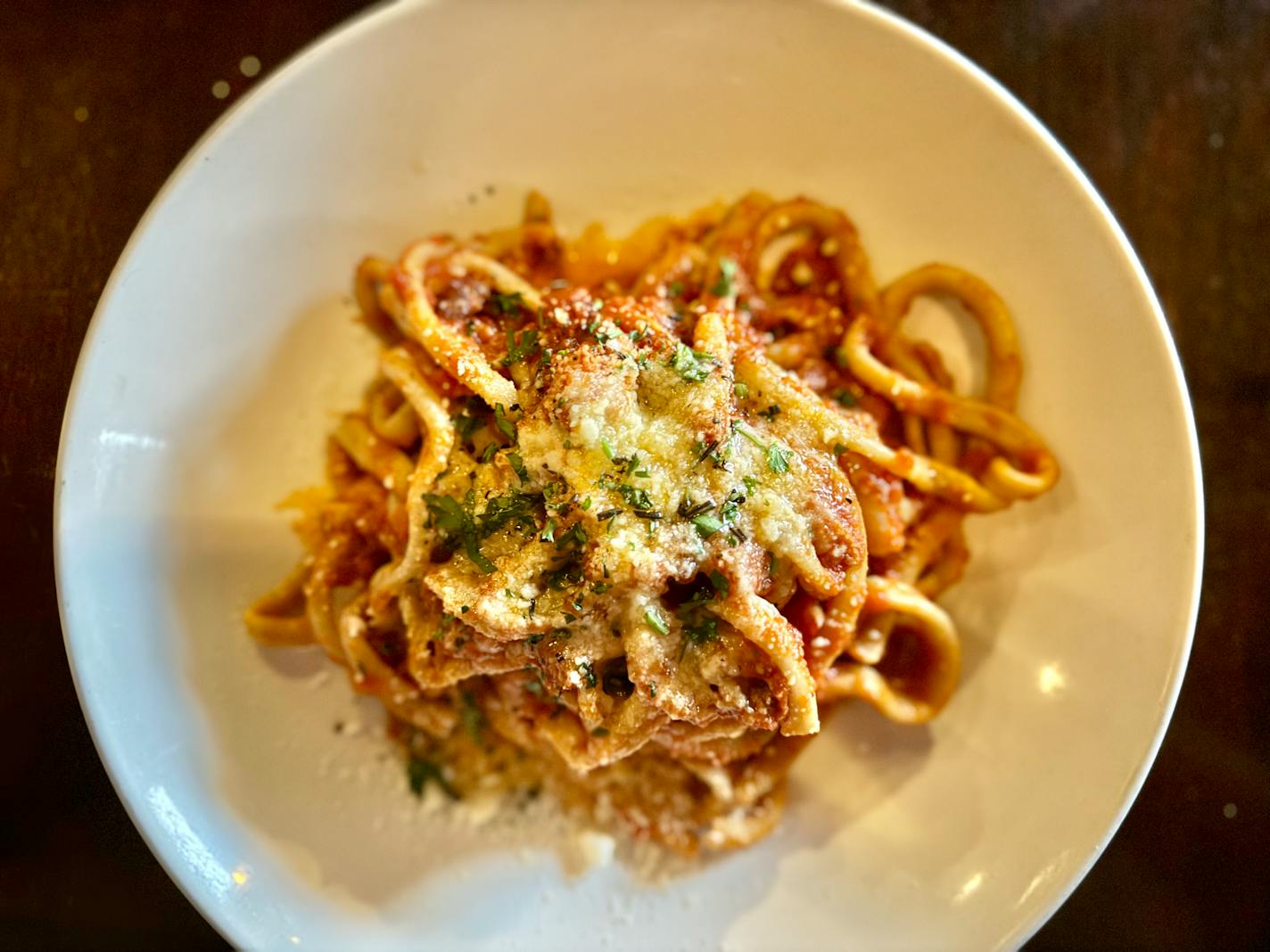 Bucatini all’Amatriciana at Rinata is served with long slurpy noodles and shaved parmesan.