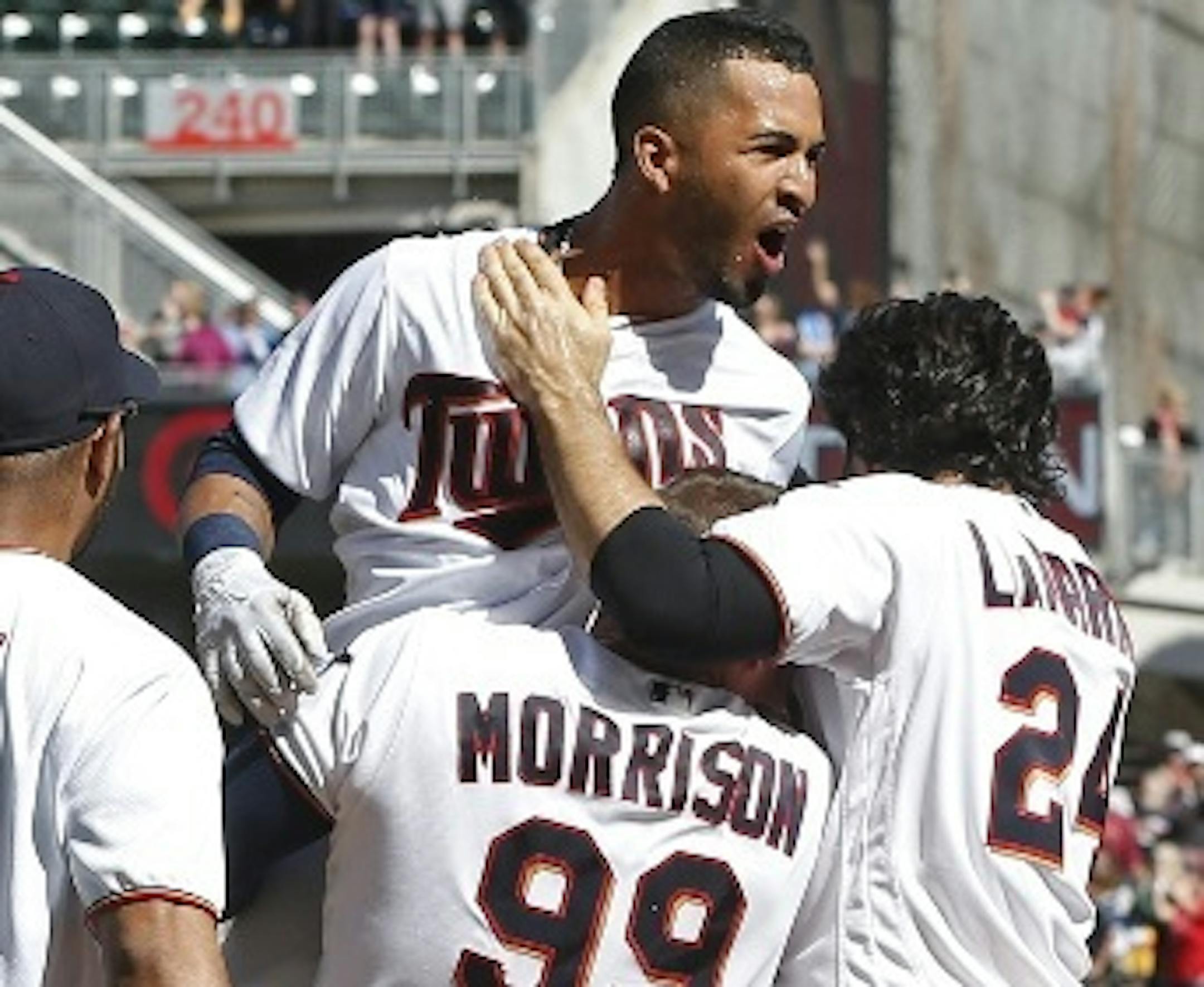 Eddie Rosario celebrated at home plate with his Twins teammates after his walkoff two-run home run off Indians pitcher Cody Allen in the ninth inning Sunday, his third home run of the game.