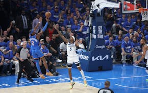 Oklahoma City Thunder guard Shai Gilgeous-Alexander (2) shoots over Timberwolves forward Jaden McDaniels (3) in the first quarter.