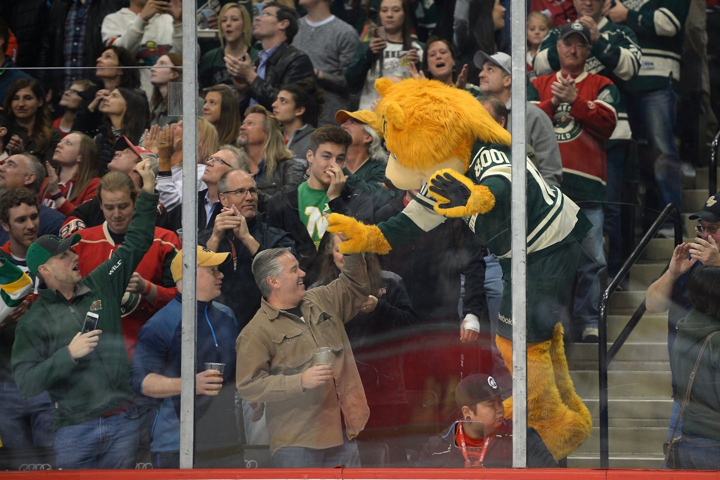 Minnesota Wild mascot, Nordy, high fived a fan after a goal by left wing Erik Haula (56) in the third period against the Chicago Blackhawks.