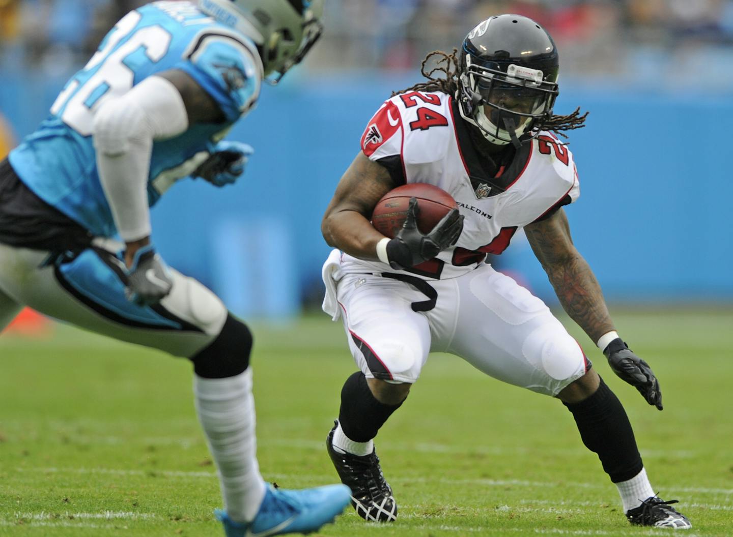 FILE - In this Nov. 5, 2017, file photo, Atlanta Falcons' Devonta Freeman (24) runs as Carolina Panthers' Daryl Worley (26) defends in the first half of an NFL football game in Charlotte, N.C. Freeman, the league&#xed;s highest-paid running back, seems likely to miss a game Monday, Nov. 20, 2017, at Seattle following his second concussion in four months. (AP Photo/Mike McCarn, File) ORG XMIT: NY801