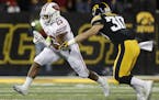 Wisconsin running back Jonathan Taylor, left, runs the ball as Iowa defensive back Jake Gervase, right, defends during the first half of an NCAA colle