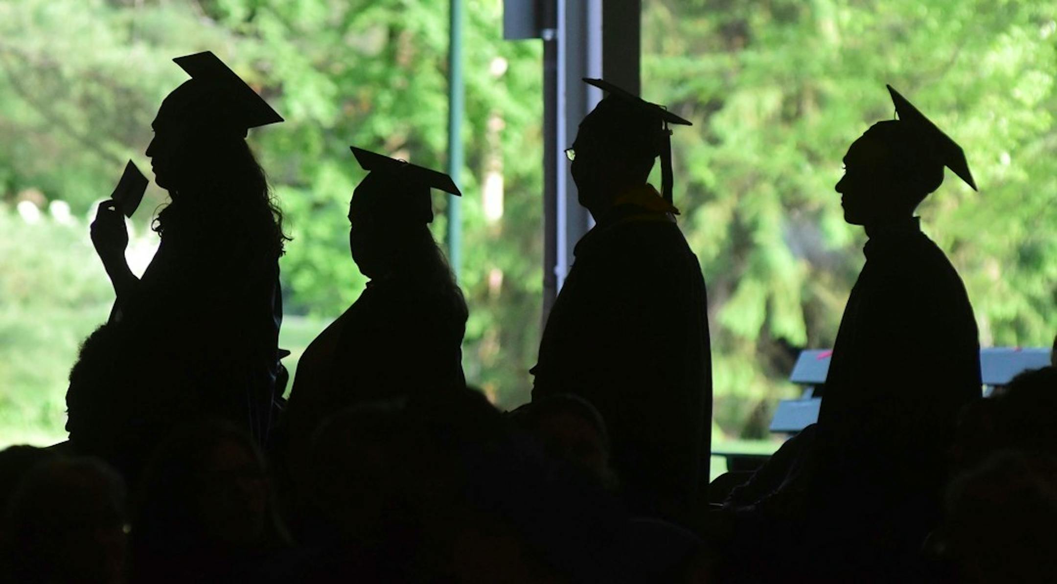 Graduates lined up to receive their diplomas at Berkshire Community College's 2018 commencement in Lenox, Mass. Some lenders advertise their products as a way to pay for college, but these aren't technically student loans. For unsuspecting students, that could lead to unnecessarily high costs and a lack of consumer protection.