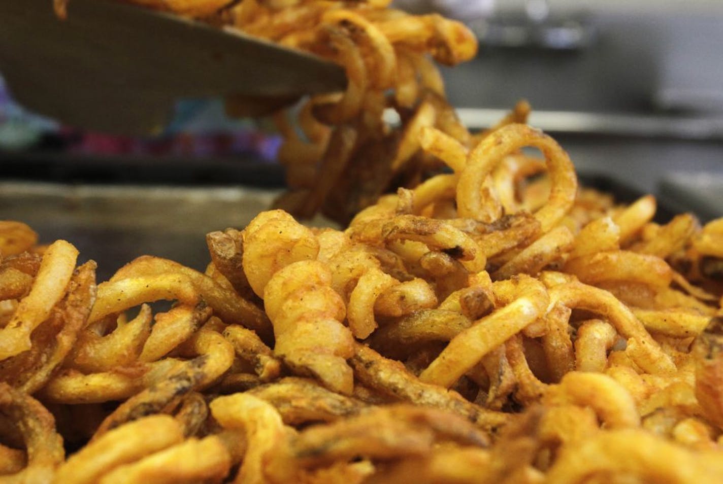 FILE - In this Sept. 14, 2011 file photo, fresh fries are scooped into containers during lunch at Gardiner High School in Gardiner, Maine. Congress wants to keep pizza and french fries on school lunch lines, fighting back against an Obama administration proposal to make school lunches healthier. The final version of a spending bill released late Monday would unravel school lunch standards the Agriculture Department proposed earlier this year, which included limiting the use of potatoes on the lu