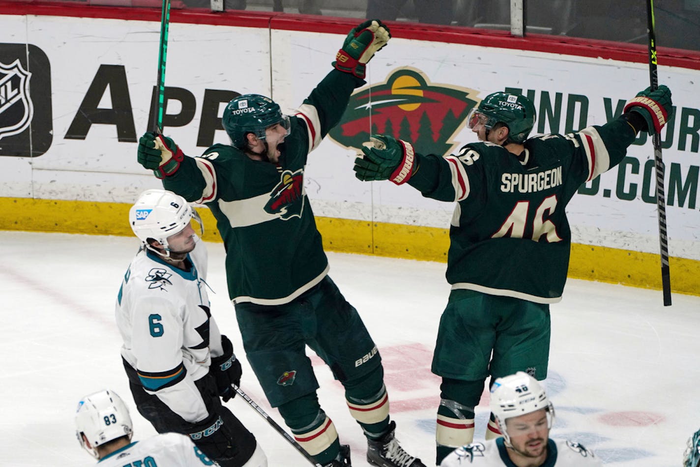 Kevin Fiala, center, and Jared Spurgeon (46) celebrate an overtime game winner in April.