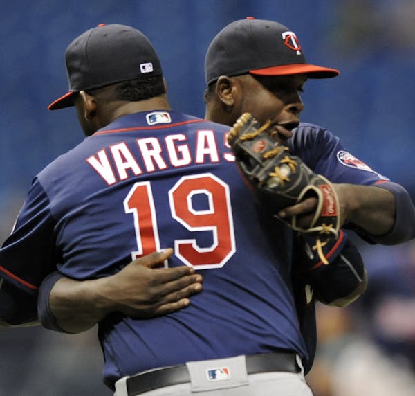 Minnesota Twins' Miguel Sano, right, and Kennys Vargas (19) celebrate a win over the Tampa Bay Rays in a baseball game Sunday, Aug. 7, 2016, in St. Pe
