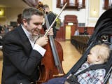 Cello player Richard Belcher plays for his 14-month-old son Finn before performing int he concert. ] LEILA NAVIDI &#xef; leila.navidi@startribune.com 