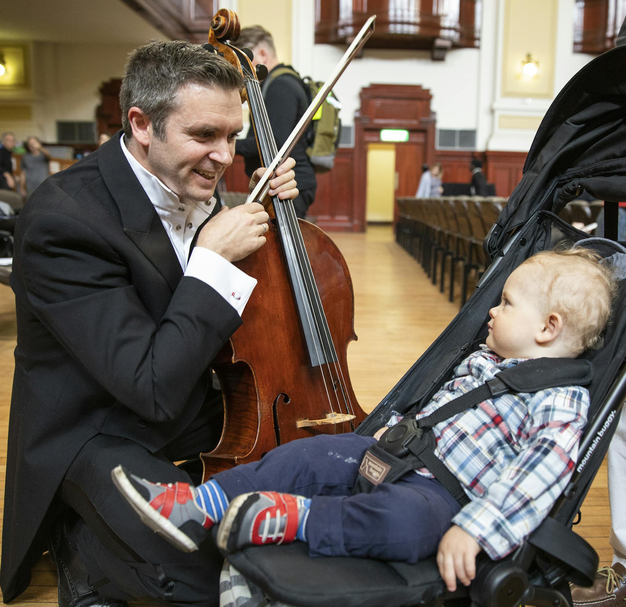 Cello player Richard Belcher plays for his 14-month-old son Finn before performing int he concert. ] LEILA NAVIDI ï leila.navidi@startribune.com BACKGROUND INFORMATION: The Minnesota Orchestra performs a concert at City Hall in Johannesburg on Saturday, August 18, 2018.