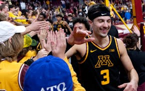 Dawson Garcia celebrated with the Williams Arena student section at the end of the game Tuesday.