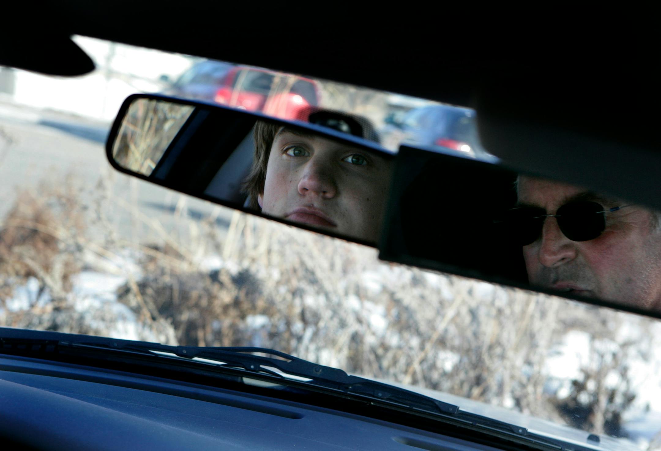 Highland Park High School student Joe Totten, 15, checked his rear-view mirror in a session with driver's education instructor John Kunz.