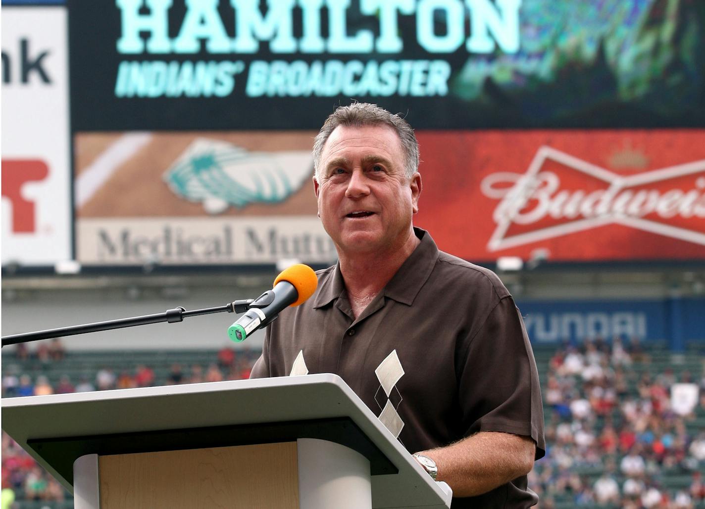 Cleveland Indians radio announcer Tom Hamilton talks after being honored for 25 years of broadcasting, prior to the Indians' baseball game against the Texas Rangers on Friday, Aug. 1, 2014, in Cleveland. (AP Photo/Aaron Josefczyk)