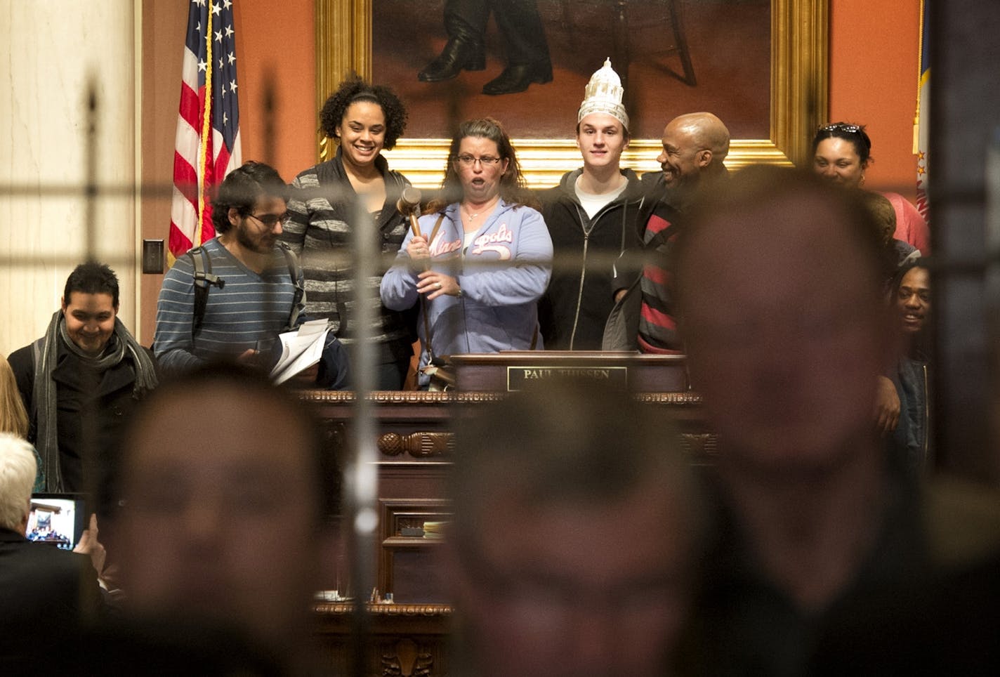 While the gun bill announcement was going on in unusual location, front of the House Chamber, a group of visiting MCTC students played with the gavel and posed for a photo. Fourteen faculty and students of a state and local government class toured the Capitol. A bipartisan group of lawmakers and members of the Minnesota Sheriff's Association stood in front of the House chambers to introduce an alternative gun bill that doesn't include background checks. The bill's author is Rep. Debra Hilstrom,
