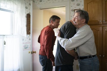 After most morning hockey games, buddies come over to Mark Sertich's house for coffee and conversation. Sertich hugged Bob Somers after he and Dane Yo