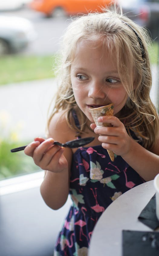 Harper Mitchelides, 5, bit into her ice cream cone at Milkjam.
