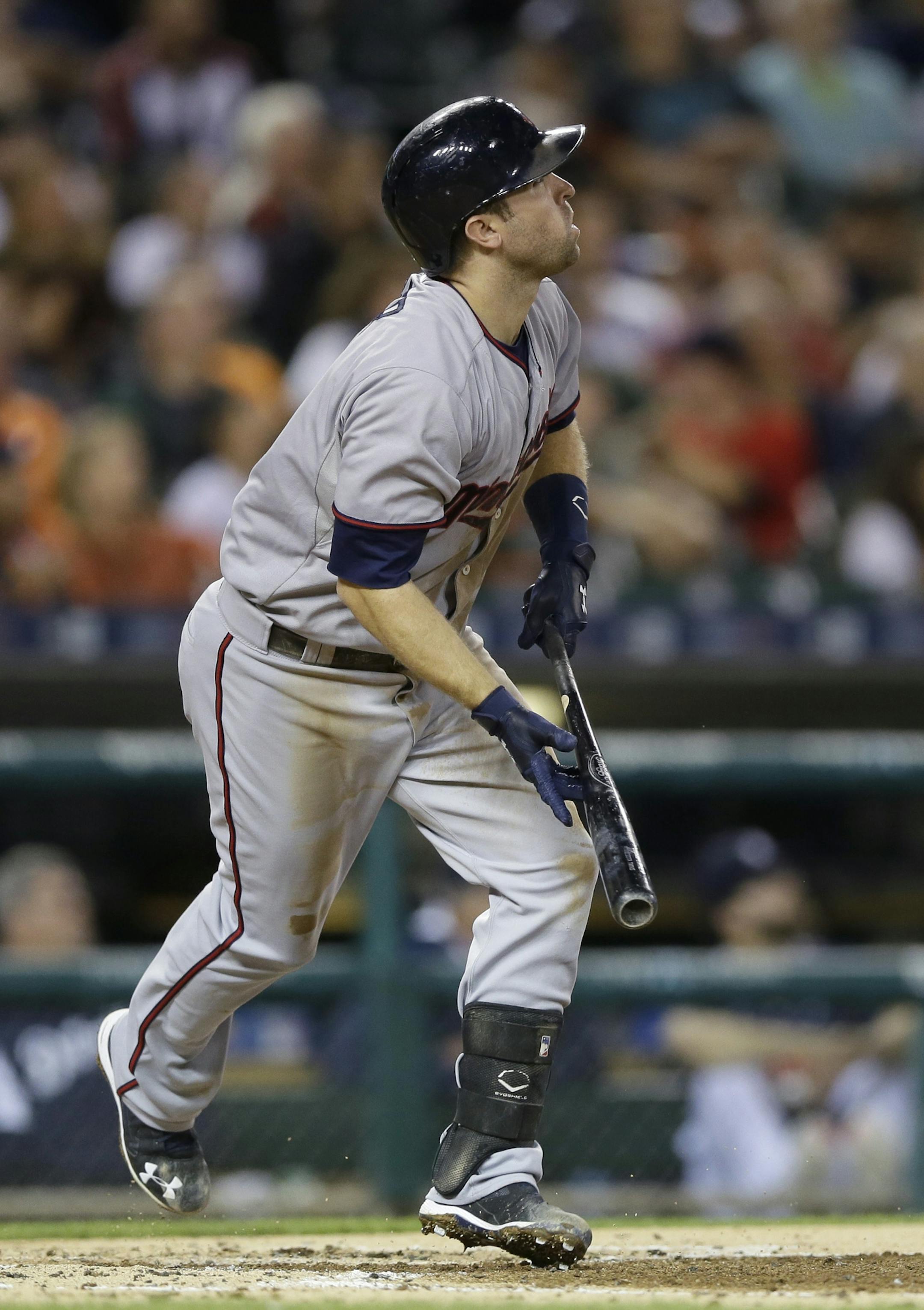 Minnesota Twins' Brian Dozier watches his sacrifice fly to center which scored Eduardo Escobar from third during the third inning of a baseball game against the Detroit Tigers, Saturday, Sept. 26, 2015 in Detroit. (AP Photo/Carlos Osorio)