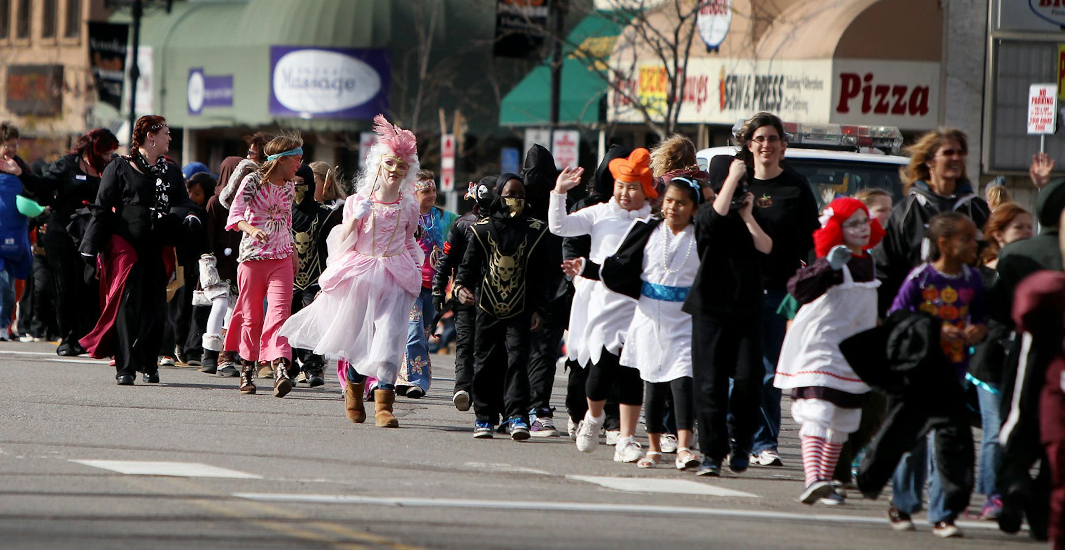 ELIZABETH FLORES &#x2022; eflores@startribune.com October 29, 2010 - Anoka, MN - The annual Anoka Halloween parade. IN THIS PHOTO:] Children dressed in their costumes waved in the 90th annual Anoka Holloween parade as it made its way down Main Street in downtown Anoka. The two-day parade tradition began in 1920. Anoka is known as the "Halloween Capital of the World."