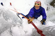 Lou Renner search for the final spot to drive in his ice axe as he topped out on an ice route Wednesday afternoon at Robinson Park.