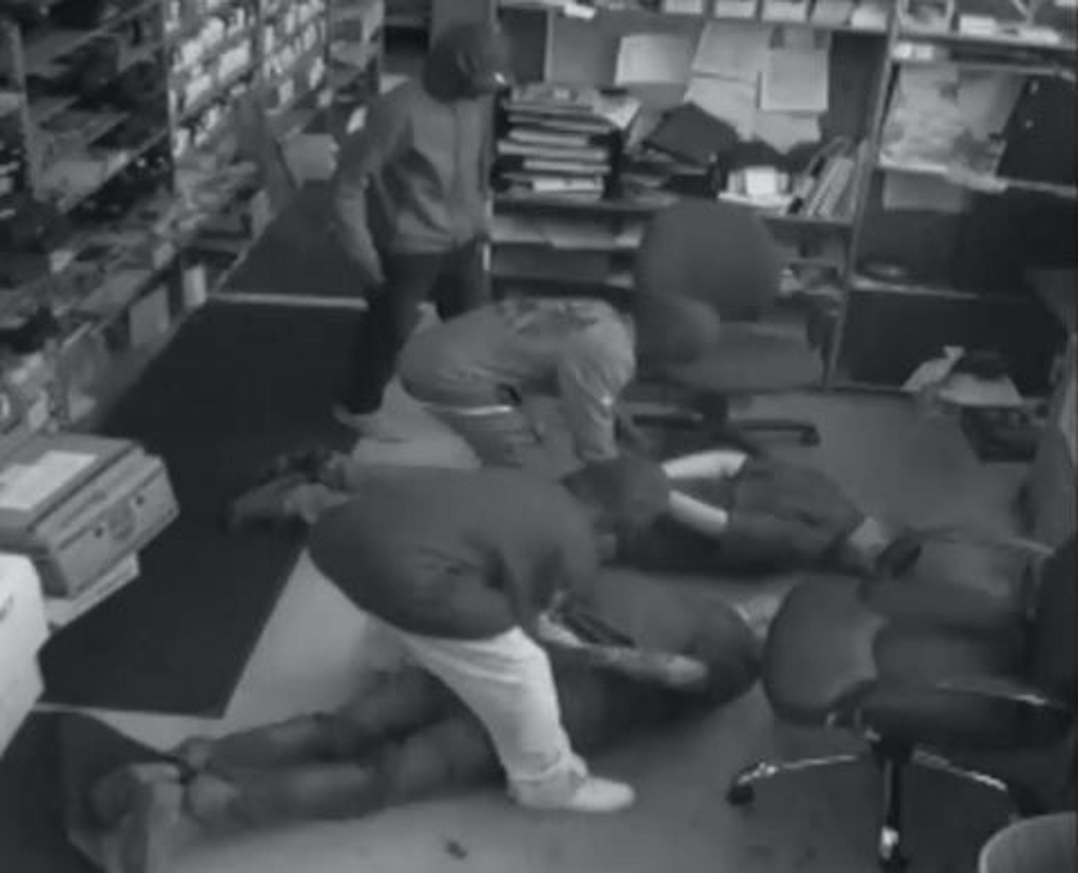 Three of the defendants tie up employees at an auto parts store.
Credit: U.S. District Court file