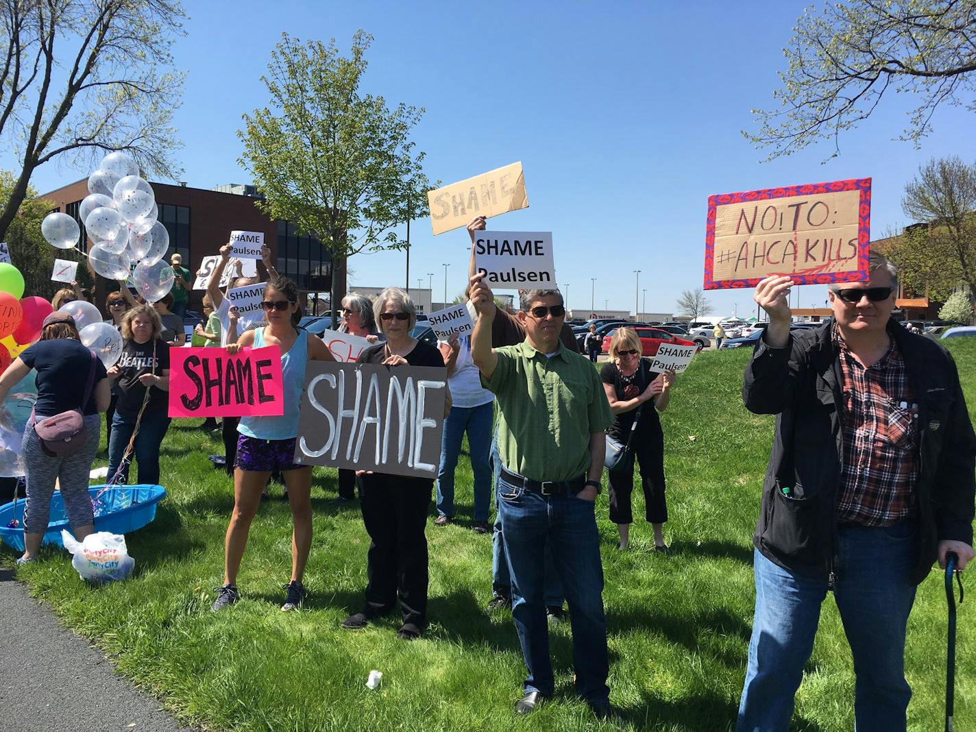 Protesters gathered outside the office of Rep. Erik Paulsen in Eden Prairie on May 5 following his health care vote.