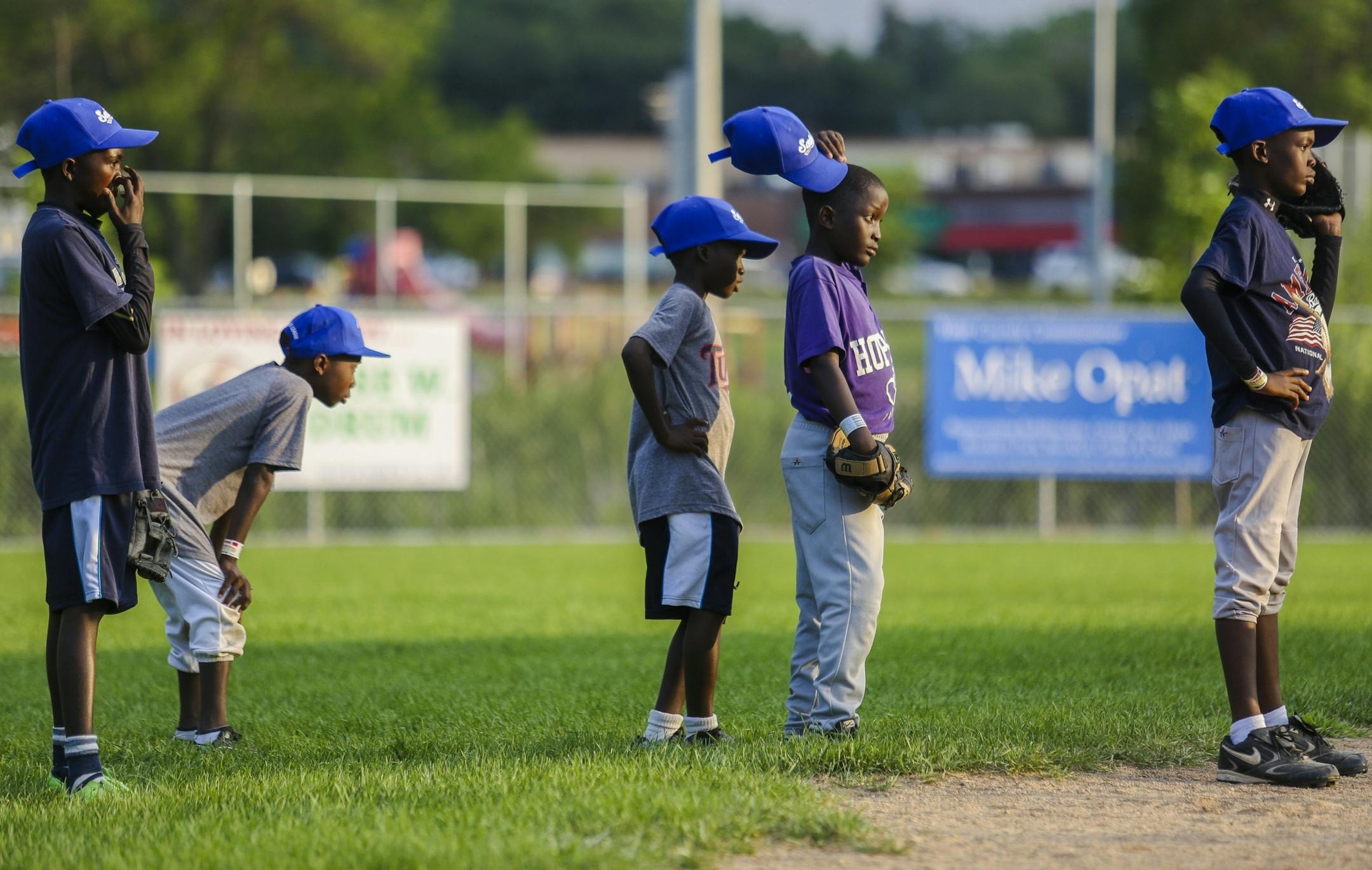 From left, Henri Joel Sanou, Carlos Agoua, Bill Sagbo, Abdoul Mamadou and Vibel Aboue wait in line to practice fielding groud balls at Lakeview Terrace Park on Monday, August 1, 2016 in Robbinsdale.