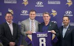 Minnesota Vikings Head Coach Mike Zimmer, left, stood next to Kirk Cousins, along with general manager Rick Spielman and co-owner Mark Wilf as he offi