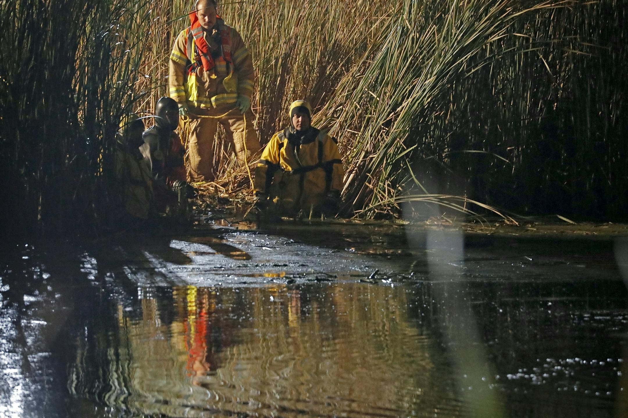 Authorities search the pond.