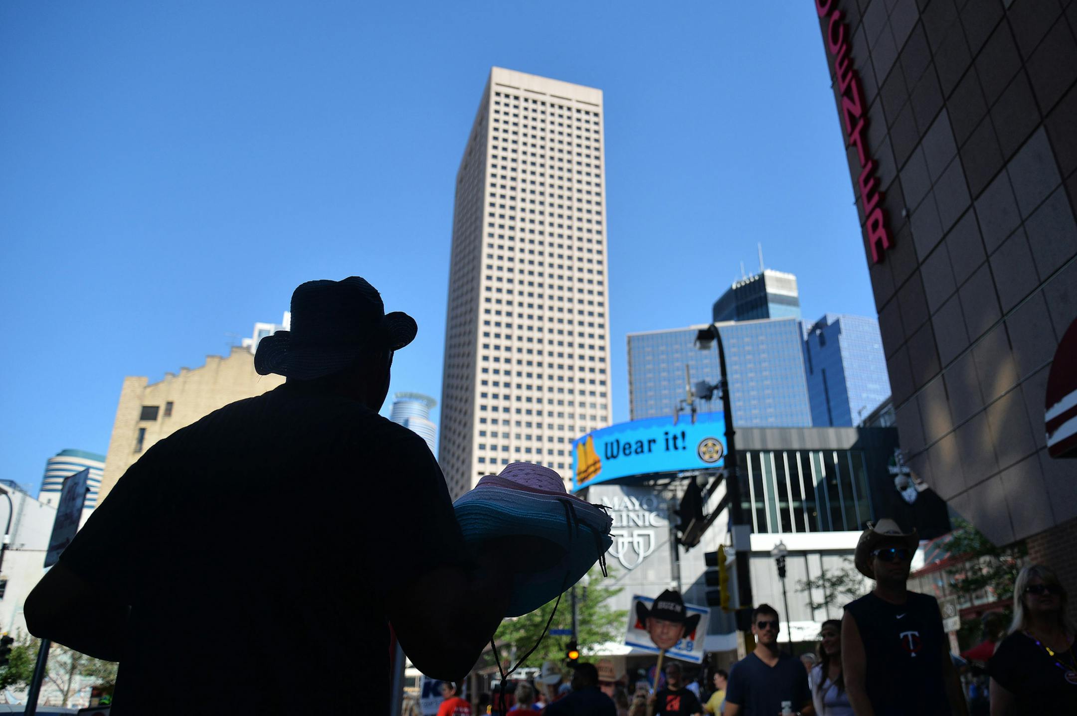 Ronnie Johnson, left, of Michigan, sold hats to people before The Big Revival and Burn It Down Tour at Target Field in Minneapolis, Minn., on Saturday July 18, 2015. Johnson has been following the tour for a month and a half selling hats and t-shirts. ] RACHEL WOOLF ∑ rachel.woolf@startribune.com