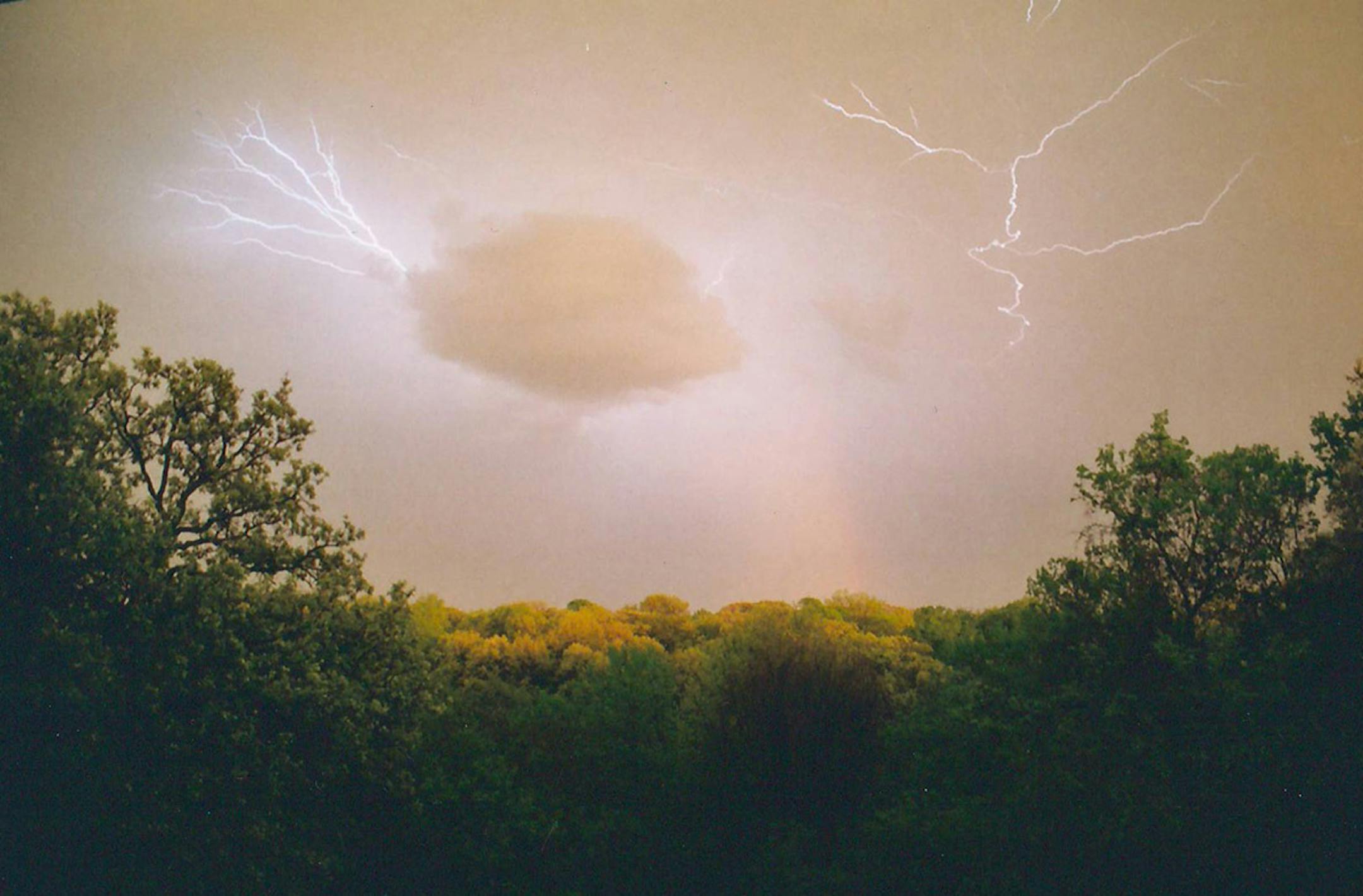Margaret Davis of Bloomington was hoping to get a picture of lightning during this summer shower, and was surprised at this shot. [focus040917